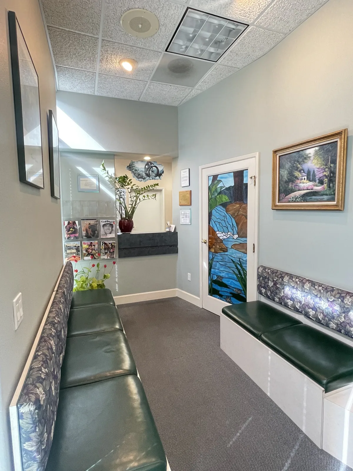Kirkwood Dental waiting room with seating and artwork